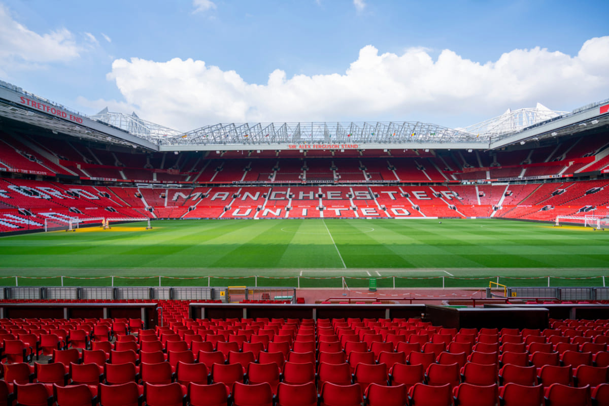 Manchester United stadium regenerationAn economic feasibility study commissioned by the Premier League club estimated that regenerating the Old Trafford area could contribute GBP7.3 billion, equivalent at the time to about $9.82 billion, to the British economy every year.When the study was released in September 2024, Manchester United was considering either building a new stadium for an estimated GBP2 billion or redeveloping Old Trafford, which had a capacity of approximately 74,000.Greater Manchester Mayor Andy Burnham supported the wider regeneration ambition but said public money would not be used to build the stadium.The surrounding neighborhood was envisioned as a mixed-use development incorporating homes, shopping centers, public spaces and new transport stations.Economic impact forecastGlobal advisory firm Oxford Economics estimated that the regeneration program could support 92,000 new jobs, deliver more than 17,000 homes and attract an additional 1.8 million visitors to the area each year.Burnham said the development had the potential to become the largest regeneration project he had seen in Britain.He expressed hope that the project would deliver the world’s best football stadium while ensuring that the surrounding community benefited from the investment.The plan was led by Manchester United co-owner Sir Jim Ratcliffe, the British billionaire who acquired a minority stake in the club in February 2024.Ratcliffe had initially raised the possibility of seeking government assistance for what he described as a “Wembley of the North.” However, Burnham’s comments indicated that the stadium itself would need to be financed privately.Manchester United appointed Foster + Partners in September 2024 to prepare a master plan for the stadium and surrounding district.The club also consulted supporters about the available options. Former Manchester United captain Gary Neville, who served on the Old Trafford Regeneration Task Force, encouraged fans to participate and share their views.New stadium chosenManchester United subsequently confirmed in March 2025 that it intended to pursue a new 100,000-seat stadium instead of redeveloping the existing ground.The proposed arena would be built next to Old Trafford and become Britain’s largest football stadium. The club estimated that construction could be completed within five years.According to the stadium announcement reported by Reuters, the venue would have a gross capacity of 104,000, placing it behind only Barcelona’s expanded Camp Nou among European football stadiums.The design produced by Foster + Partners includes a large umbrella-style canopy covering the stadium and a public plaza twice the size of London’s Trafalgar Square.Three masts would form the venue’s most recognizable architectural feature. The tallest would reach 200 meters, exceeding the height of Manchester’s 169-meter Beetham Tower and Wembley Stadium’s 135-meter arch.The club said the structure could be visible from as far as 37.4 kilometers away under favorable conditions, including parts of Cheshire, the Peak District and the outskirts of Liverpool.Faster construction plannedFoster + Partners proposed using prefabricated sections to reduce the normal stadium construction period. Components could be transported through the Manchester Ship Canal, reconnecting the project with the area’s industrial and maritime heritage.The stadium canopy is designed to collect rainwater and generate energy while protecting a new public plaza and surrounding commercial spaces.Foster + Partners said the fan experience would remain central to the design, with seating intended to bring spectators closer to the pitch and improve the stadium’s acoustics and atmosphere.The new venue would replace Old Trafford as Manchester United’s principal home. Old Trafford has hosted the club since 1910 and was rebuilt after sustaining extensive damage during the Second World War.The stadium underwent major expansions during the 1990s and 2000s but has not received a significant redevelopment since 2006. Concerns about its condition have grown following roof leaks, drainage problems and reported rodent sightings.Manchester United has also fallen behind newer Premier League venues in its ability to host concerts, corporate events and other activities outside matchdays.Wider district advancesTrafford Council backed the regeneration program in January 2025 and approved work to establish a sustainable international destination around the stadium, Manchester Ship Canal and Imperial War Museum North.The wider plan was expected at that stage to support around 48,000 local jobs, deliver approximately 15,000 homes and contribute GBP4.2 billion to the regional economy. These planning estimates used a different geographic scope and methodology from the Oxford Economics figures of 92,000 jobs, 17,000 homes and GBP7.3 billion in annual national economic value.British Chancellor Rachel Reeves also backed the regeneration concept, viewing the project as a potential driver of economic growth in Greater Manchester.The public sector’s role is focused on the surrounding district, transport connections, land assembly and infrastructure rather than paying for the football stadium.In June 2026, Manchester United reached another major milestone by securing most of the land required for the new venue.The club acquired the majority of a 25-acre site from industrial property company Indurent, providing space for the stadium approximately 350 meters northwest of Old Trafford.The land deal allowed the club to advance its plans without relying on the neighboring Freightliner rail terminal, where earlier negotiations had encountered disagreements over the site’s value.Read more: Saudi Arabia, U.S. turn 2026 and 2034 World Cups into investment platform spanning 15 stadiums across five citiesLand deal securedManchester United’s official land announcement described the stadium as the centerpiece of a 370-acre regeneration project.The latest framework is expected to deliver around 15,000 homes, including affordable housing, create approximately 48,000 jobs locally and more than 90,000 nationally, and contribute more than GBP7 billion annually to the United Kingdom’s economy.The club said the new site would allow it to preserve Old Trafford’s heritage and matchday traditions while creating a modern venue with improved facilities, accessibility and supporter experiences.Securing the land does not by itself authorize construction. The development still requires detailed design work, public consultation, planning permission, financing and coordination with local and national authorities.The final future of the existing Old Trafford stadium also remains undecided. Options could include retaining part of the ground, adapting it for another use or incorporating its heritage into the wider regeneration district.Financing remains centralThe proposed new stadium has been widely estimated to cost around GBP2 billion, although the final amount will depend on design decisions, construction costs, infrastructure requirements and the project’s financing structure.The scale of the investment presents a financial challenge for Manchester United. When the detailed plans were announced in 2025, the club’s liabilities, including outstanding transfer payments, exceeded GBP1 billion.Chief Executive Omar Berrada has acknowledged that stadium investment could affect spending in other areas, including the playing squad, during the construction period.The project’s commercial case depends partly on the increased capacity and the stadium’s ability to host events throughout the year. Additional hospitality areas, concerts, retail, dining, tourism and corporate activities could generate revenue beyond Premier League and European football matches.The wider regeneration would also need substantial investment in public transport, pedestrian routes, utilities, roads and community facilities to accommodate residents, workers and millions of additional visitors.Manchester United’s decision to build a new stadium has therefore transformed the original feasibility study into a long-term urban development program. The GBP7.3 billion estimate represents the projected annual contribution of the entire regeneration area to the British economy, rather than revenue generated solely by the football club or stadium.